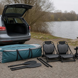 Packed tandem kayak equipment beside a car for transport