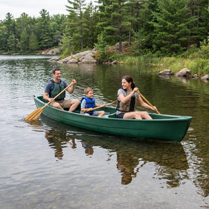 Family paddling the open canoe together